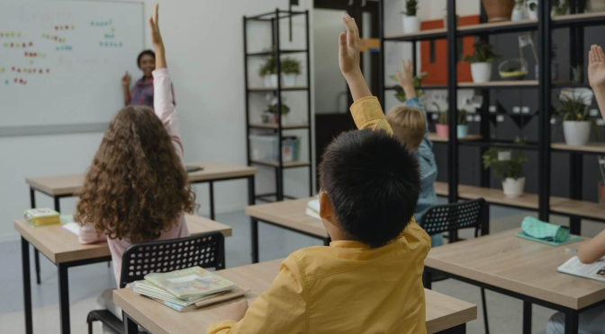 Siswa yang antusias belajar di kelas dengan metode pengajaran interaktif.